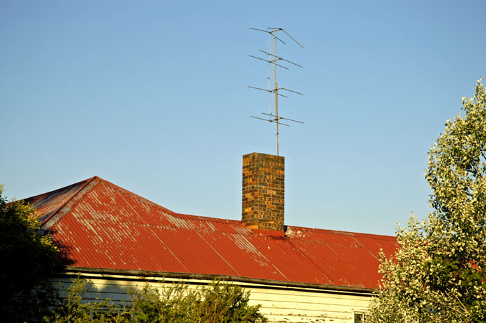Old TV antennas on old farmhouse roof