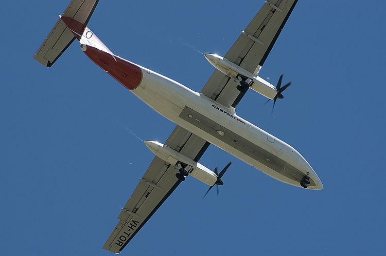 Plane overhead, wheels down, landing
